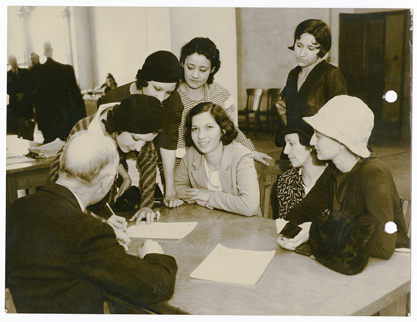 Women signing paper