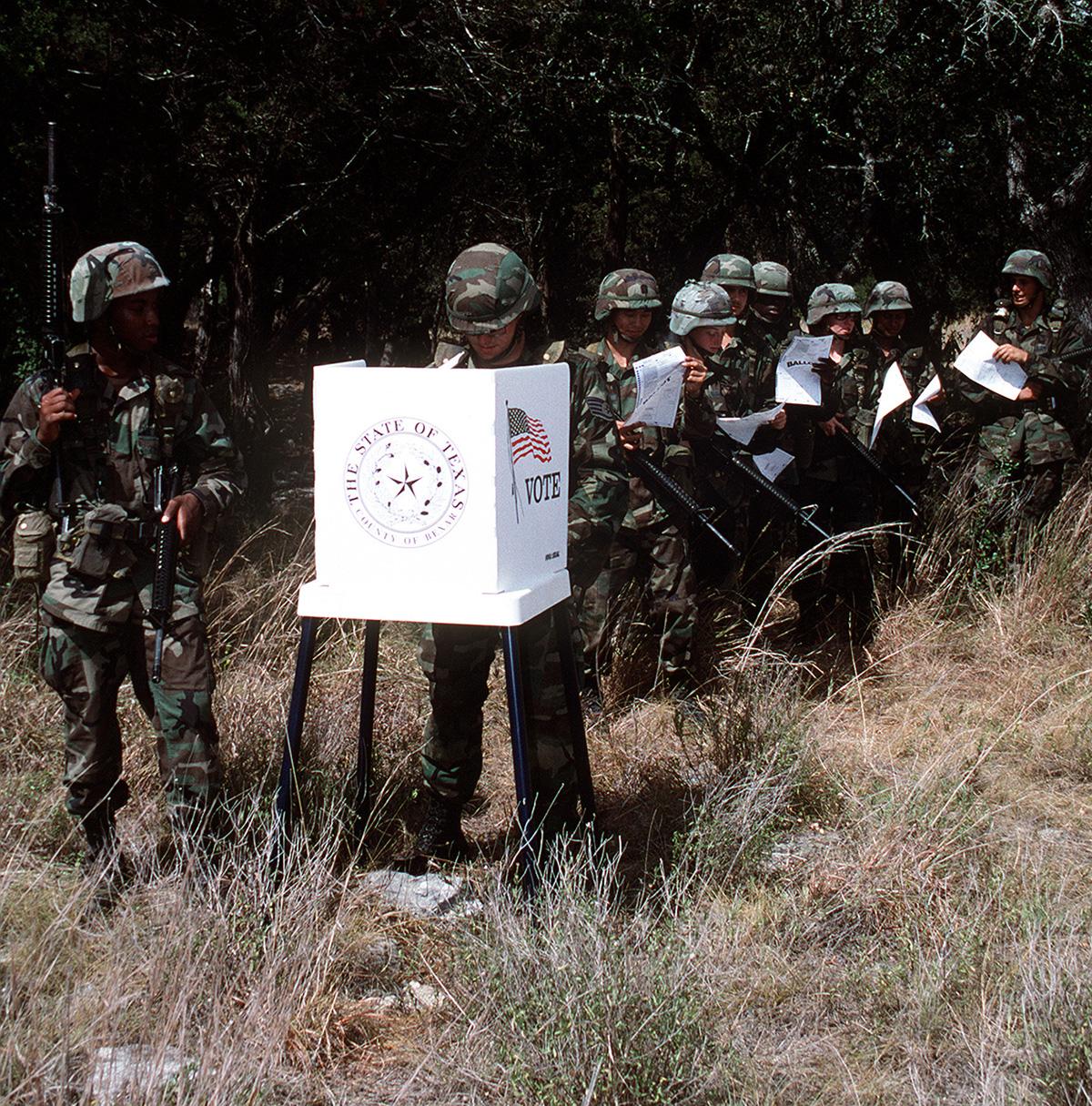 Soldiers vote in a field in Vietnam