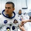 A technician places two inflight pens and a penlight in the spacesuit pocket of Apollo 8 commander Frank Borman