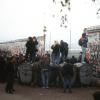 A crowd gathers at a break in the Berlin Wall