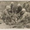 Marines aiding a wounded comrade