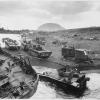 amtracs and other vehicles of war lay knocked out on the black sands of Iwo Jima