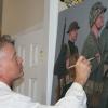 Kristopher Battles, a USMC combat artist, paints an image of marine corps troops. (Photo courtesy of Kristopher Battles)