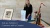 promotional poster featuring a woman standing near museum artifacts