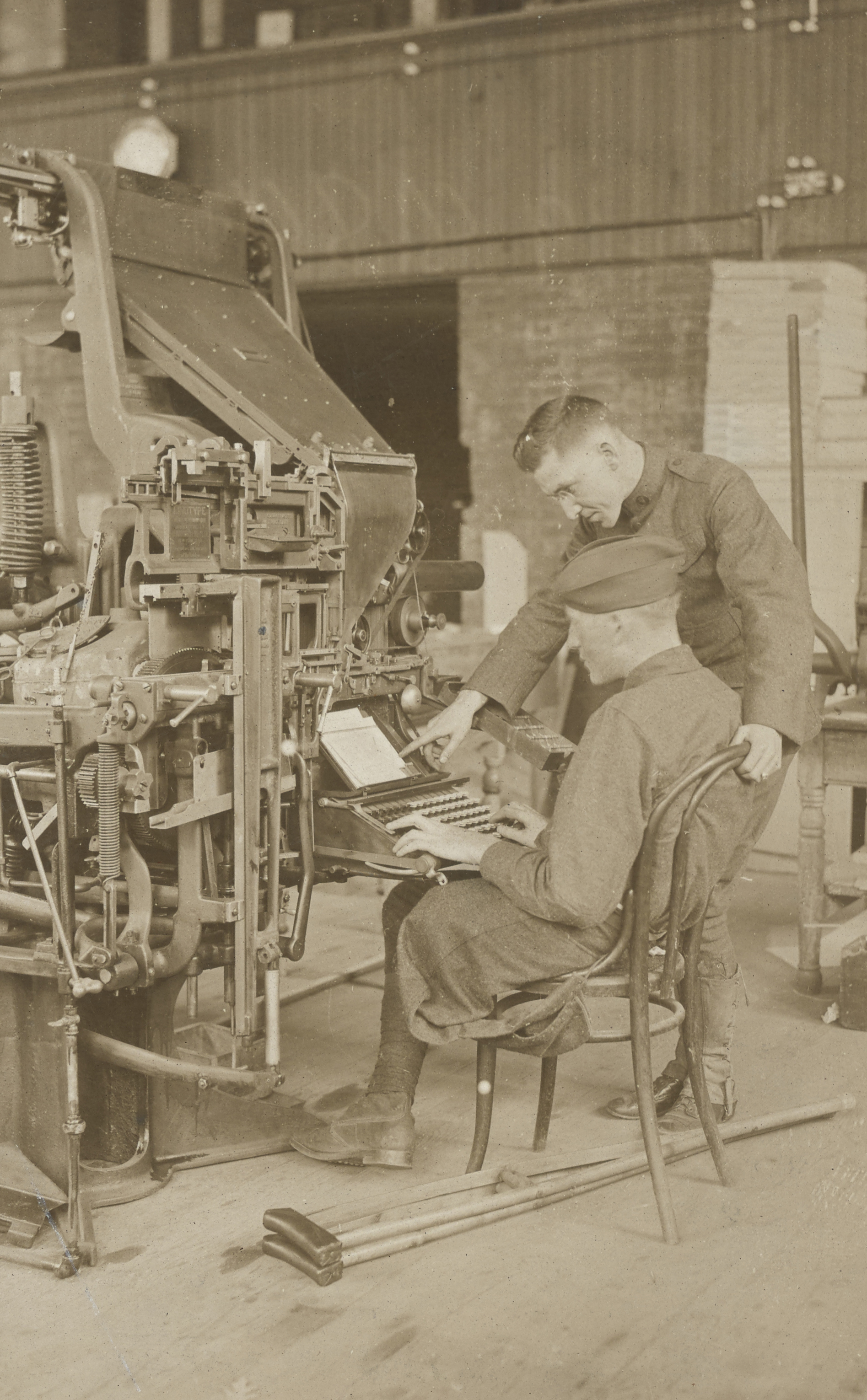 Wounded soldiers receiving instructions on linotype machine