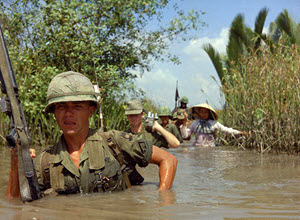 Photograph of Private Fred L. Greenleaf Crossing a Deep Irrigation Canal during Operation Bang Dong
